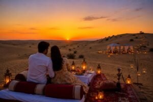 Couple seated on a desert rug at sunset, enjoying a candlelit dinner with lanterns and tents in the background